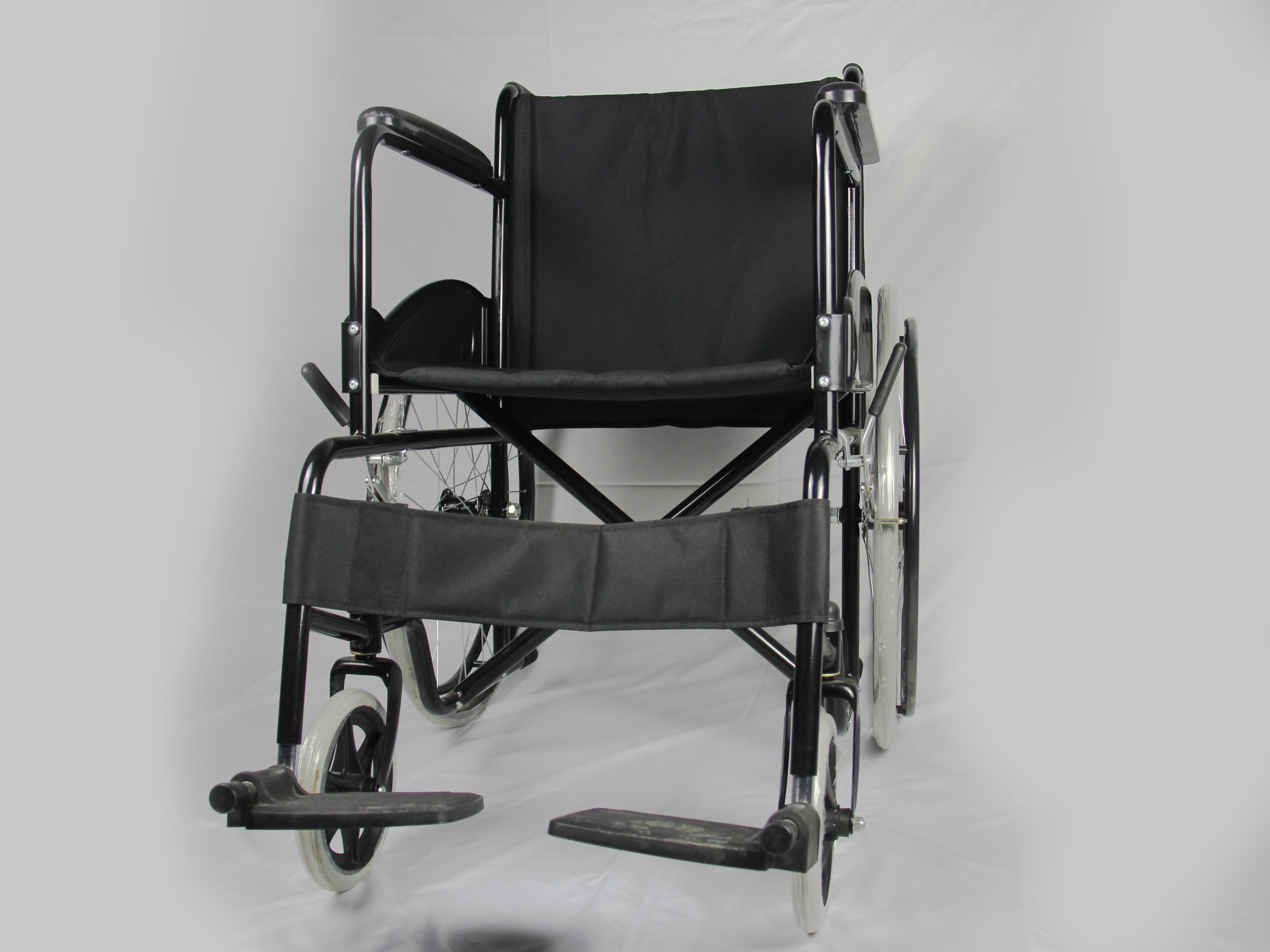 Low Price Basis Black Coating Steel Frame Folding Steel Wheelchair With Solid Wheel Fixed Armrest And Footrest