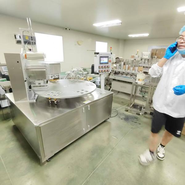 Close-up view of disc rotary sealing machine components