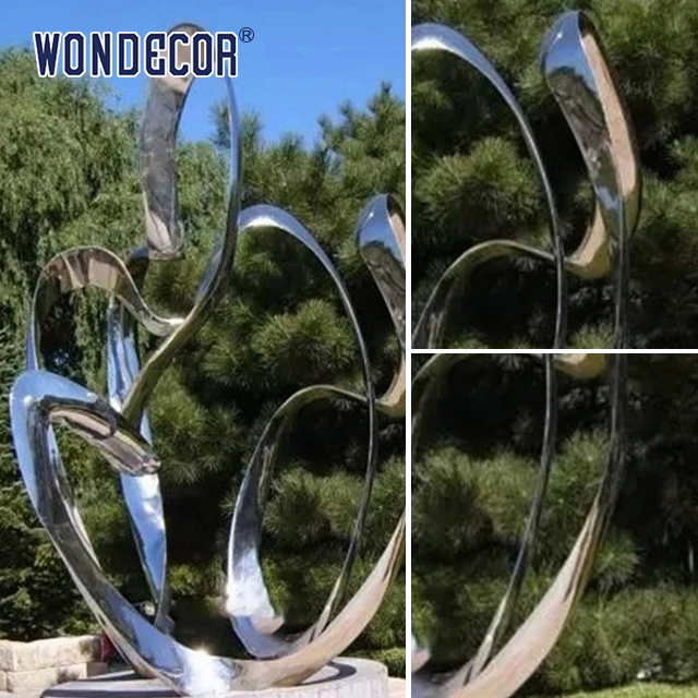 Large rotating stainless steel sculpture outdoor square park