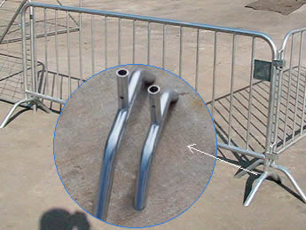 Two pieces of crowd control barriers are connected with the two bridge feet cross each other and a detail picture of the bridge feet.