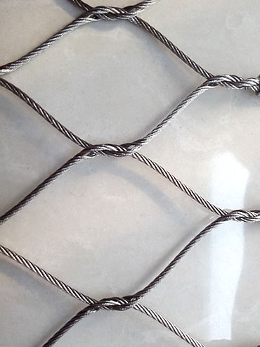 A part of knotted rope mesh is on the floor.