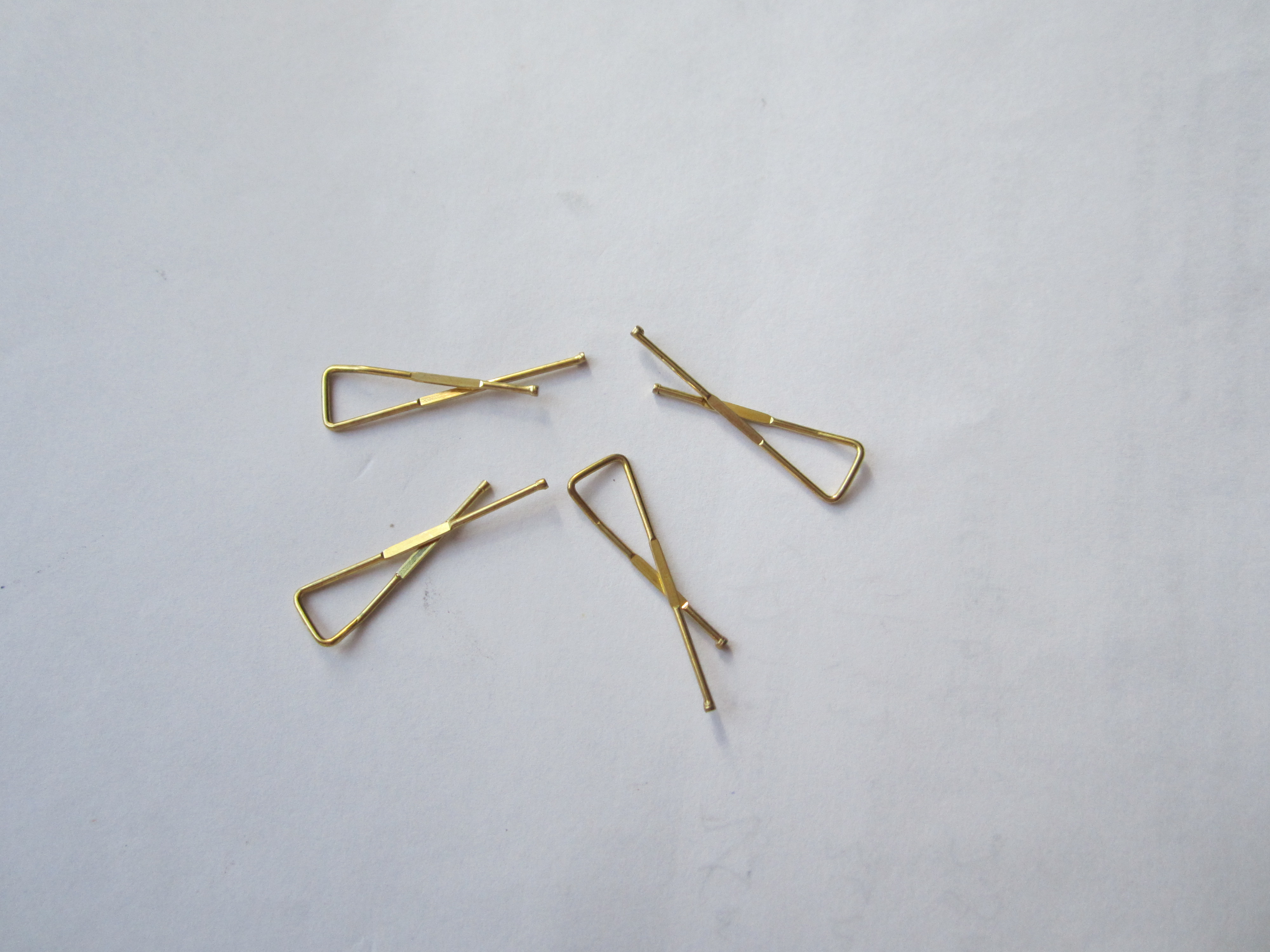 Brass X shaped clip for t-shirt