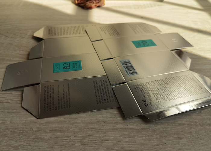 Factory supplying customized silver paper cosmetics essence packaging boxes