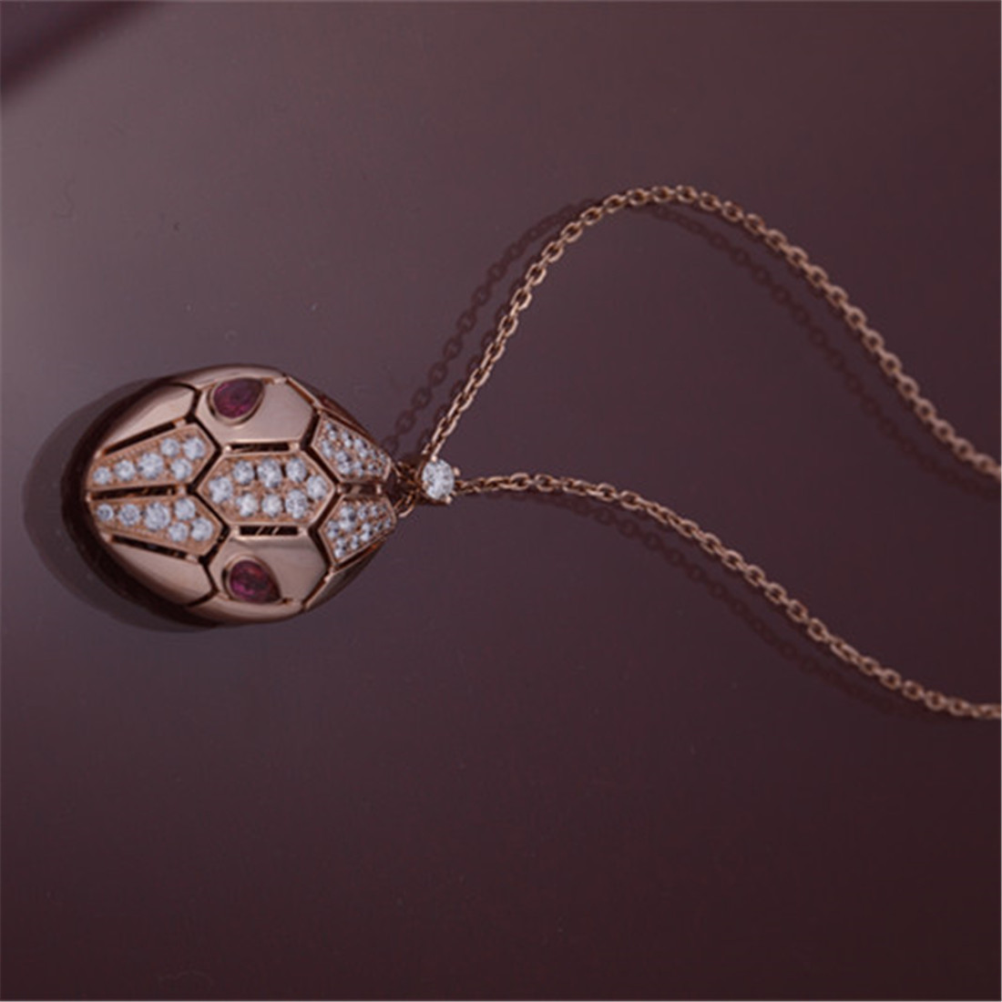 Roman Serpenti necklace in 18 kt rose gold set with rubellite eyes and with pavé diamonds on the head