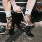 Camp shower being used to rinse muddy feet